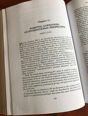 Photo of book opened to Chapter 11: Parental Alienation: An International Perspective by Ashish Joshi